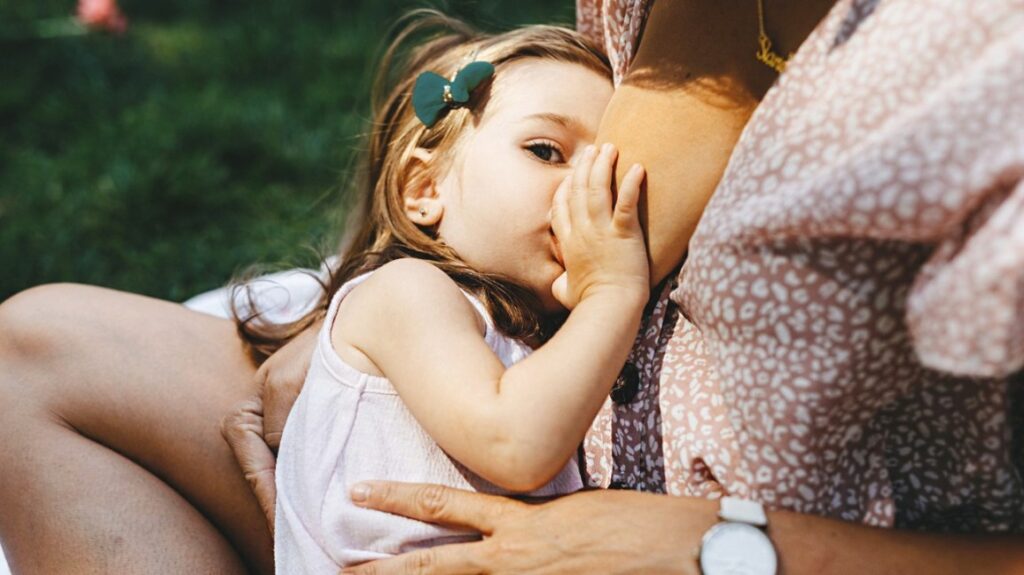 toddler breastfeeding outdoors 1296x728 header2