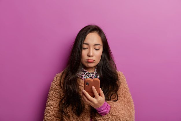 photo gloomy brunette woman looks screen mobile phone with sad face reads bad news feels dissatisfaction after receiving message 273609 38533