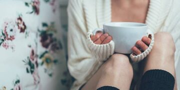 Girl drinking tea in bed