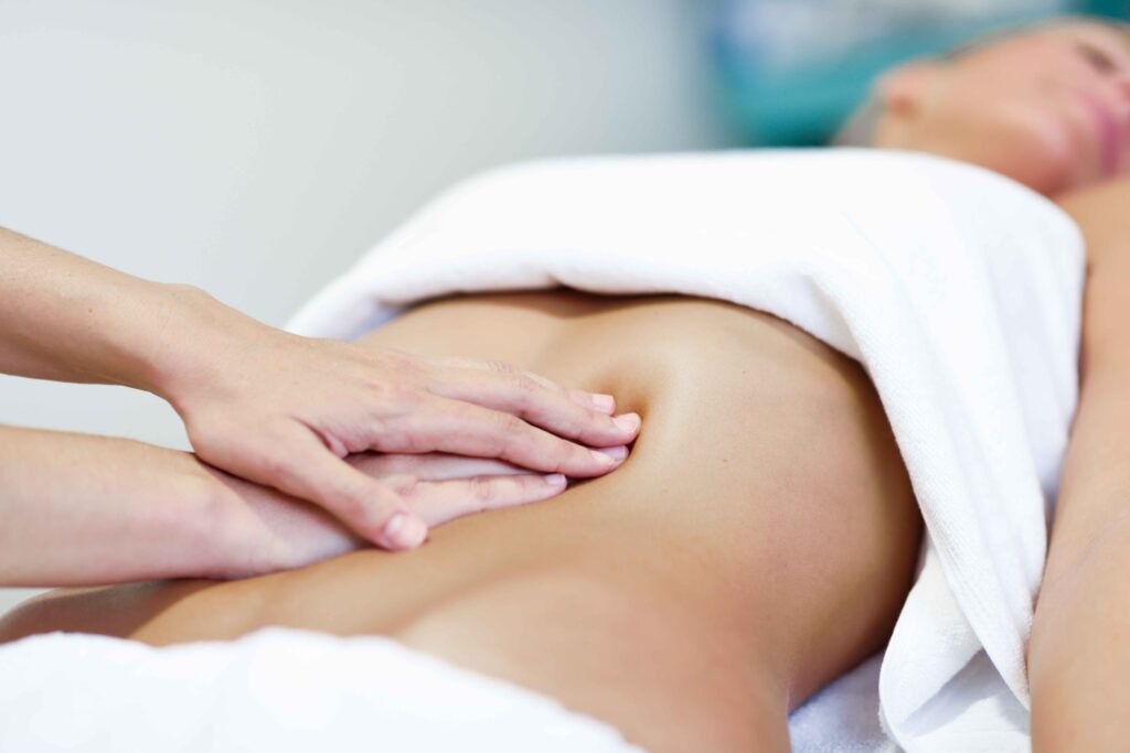hands massaging female abdomen therapist applying pressure belly 11zon