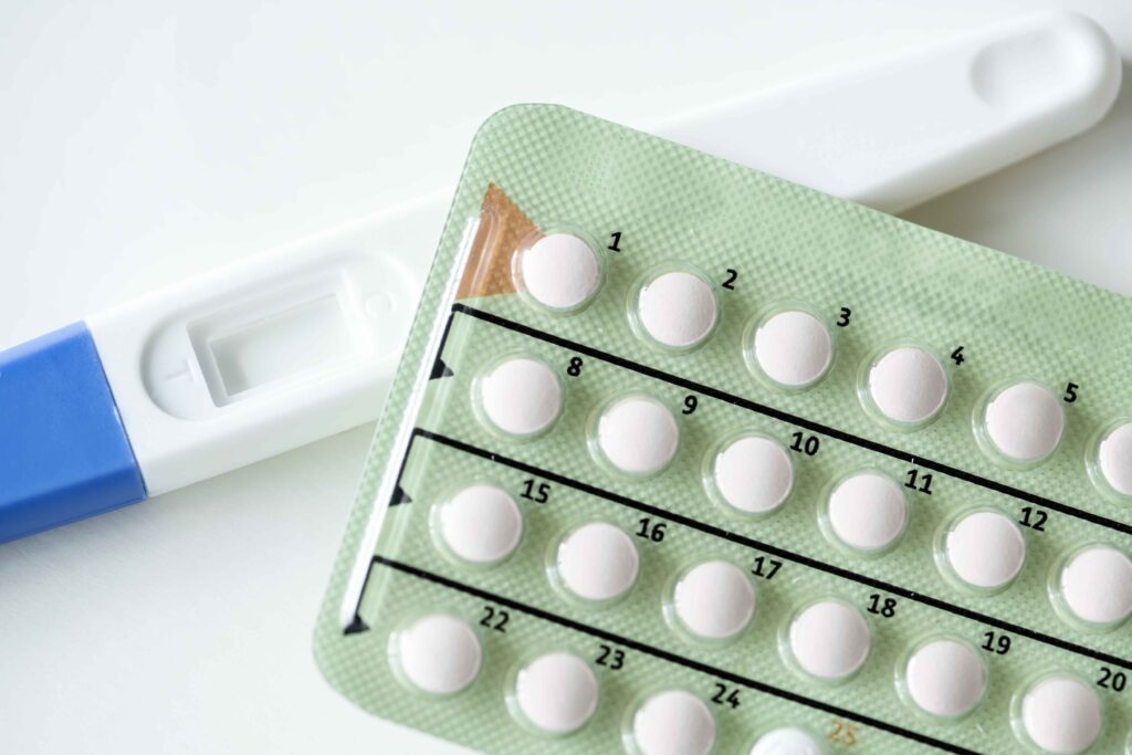 closeup pregnancy test contraceptive pills birth control concept 11zon