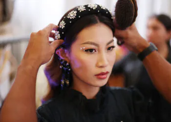 LONDON, ENGLAND - SEPTEMBER 20: A model is prepared backstage ahead of the Klamby SS23 runway show presented by Wardah, during London Fashion Week on September 20, 2022 in London, England. (Photo by Tim P. Whitby/Getty Images for Klamby)